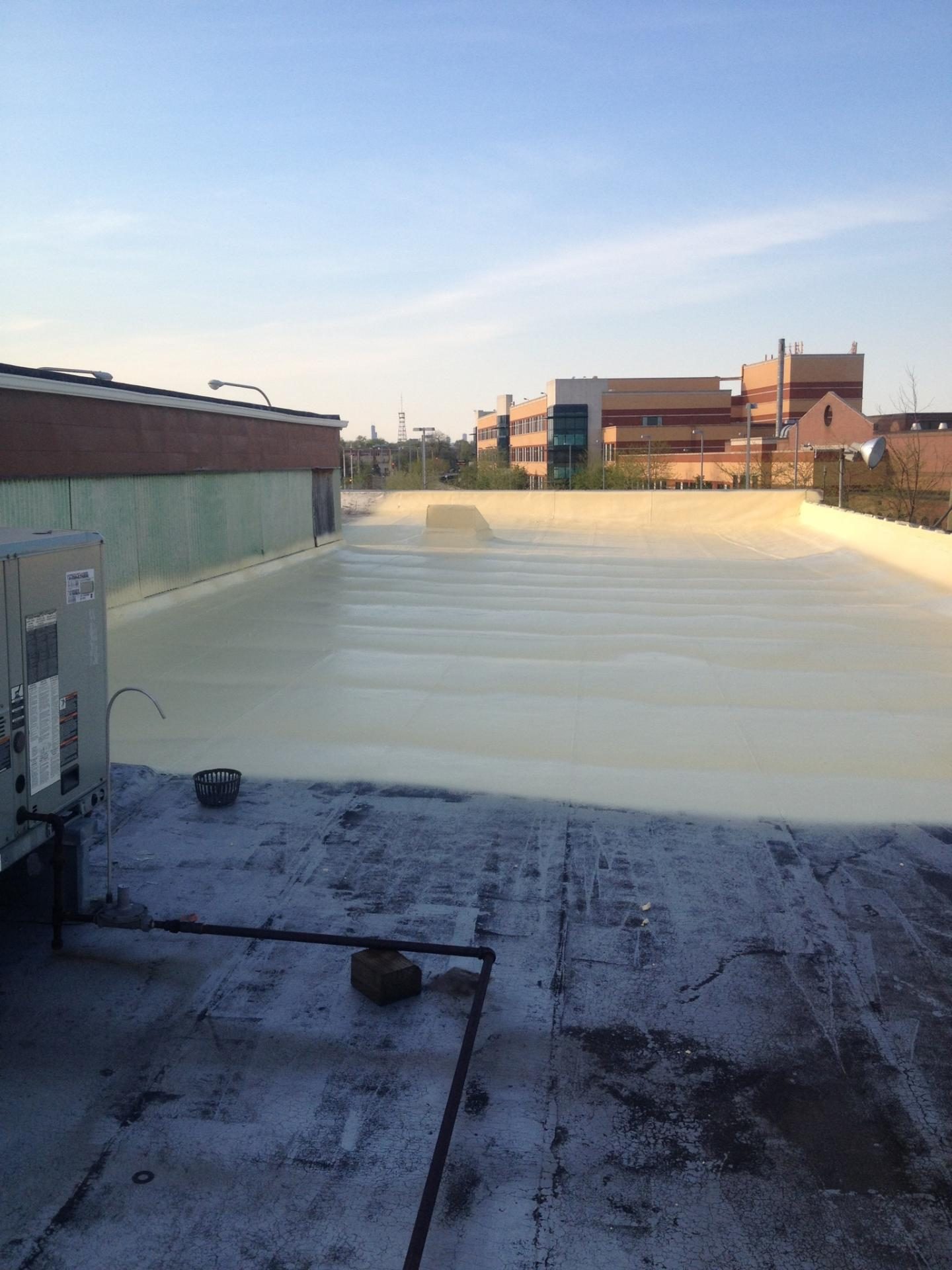 Crew-applied liquid shingles restoration on a residential roof